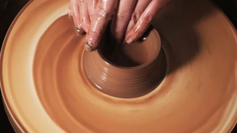 Hands working clay on potter's wheel. Potter shapes the clay product with potter Video stock 144068447