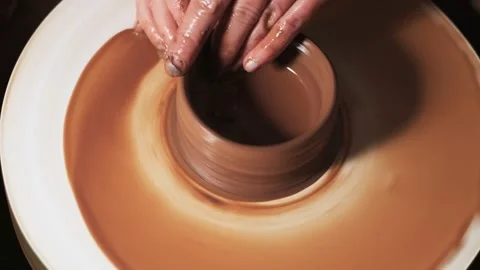 Hands working clay on potter's wheel. Potter shapes the clay product with potter Video stock 144068588