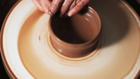 Hands working clay on potter's wheel. Potter shapes the clay product with potter Video stock 144068769