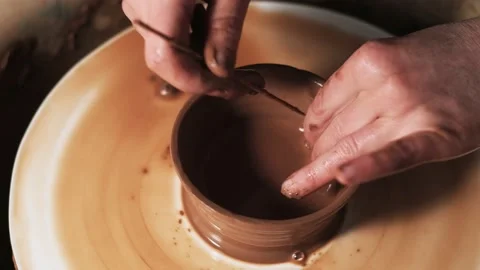 Hands working clay on potter's wheel. Potter shapes the clay product with potter Video stock 144069044