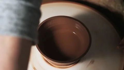 Hands working clay on potter's wheel. Potter shapes the clay product with potter Video stock 144069464