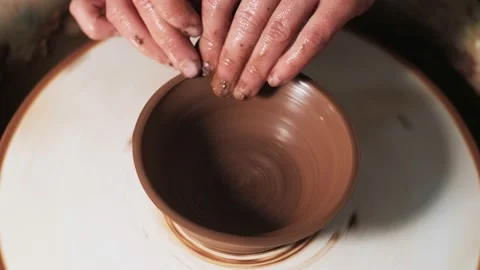 Hands working clay on potter's wheel. Potter shapes the clay product with potter Video stock 144069596