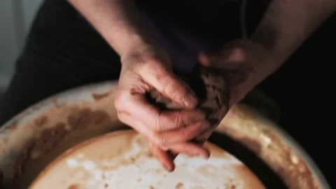 Hands working clay on potter's wheel. Potter shapes the clay product with potter Video stock 144069891