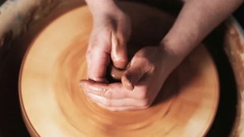 Hands working clay on potter's wheel. Potter shapes the clay product with potter Video stock 144070714