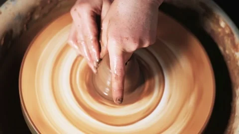 Hands working clay on potter's wheel. Potter shapes the clay product with potter 動画素材 144070987
