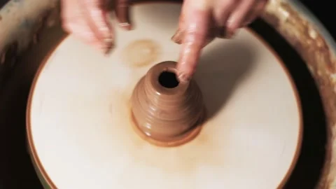 Hands working clay on potter's wheel. Potter shapes the clay product with potter Video stock 144071260