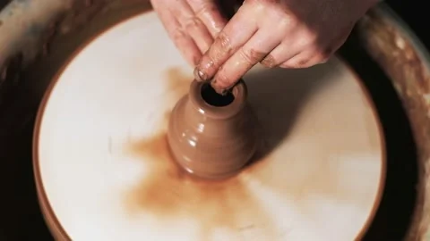 Hands working clay on potter's wheel. Potter shapes the clay product with potter Video stock 144071748