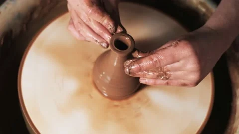 Hands working clay on potter's wheel. Potter shapes the clay product with potter Stock Footage 144072168