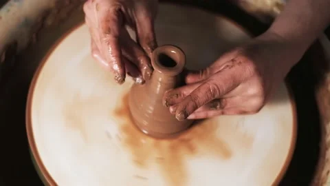 Hands working clay on potter's wheel. Potter shapes the clay product with potter Video stock 144072568