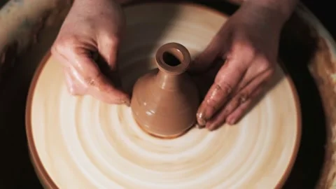Hands working clay on potter's wheel. Potter shapes the clay product with potter Stock Footage 144073211