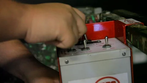 Hands working controls on scissor lift or construction equipment switches Stock Footage 125635103