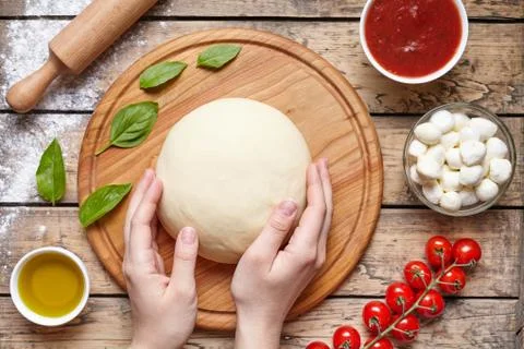 Hands working with dough preparation pizza or pie making ingridients, food flat Stock Photos