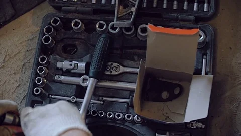 Hands in working gloves remove the nozzle from the key and put it in the tool Stock Footage 77177273