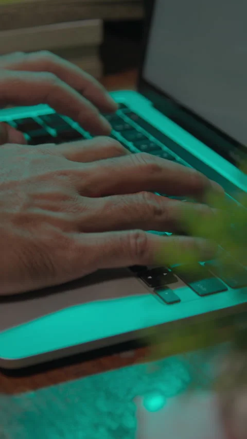 Hands working on a laptop keyboard in a calm indoor setting Stock Footage 333958501