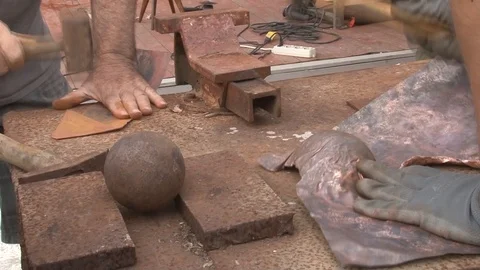 Hands of working men using hammers to work metal in a construction site Stock Footage 117360264
