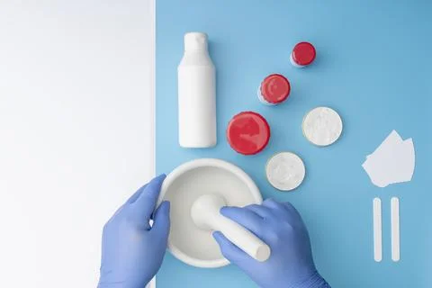 Hands working with a mortar.For ointment and cream preparation. Stock Photos