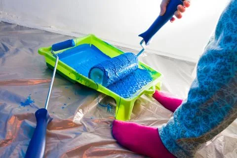 Hands working with painting roller Stock Photos