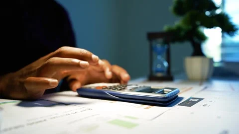 Hands working with paperwork and calculator at office desk, Close-up of han.. Video stock 346462548
