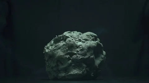 Hands working a piece of steaming clay on a black background Stock Footage 125818085