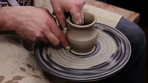 Hands working on pottery wheel Stockbeeldmateriaal 70671503