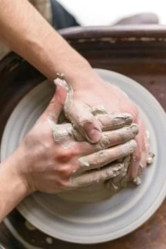 Hands working on pottery wheel Stock Photos