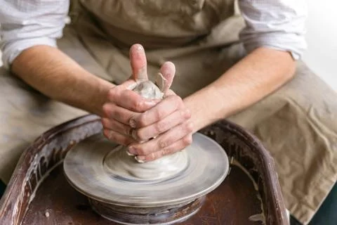 Hands working on pottery wheel Stock Photos
