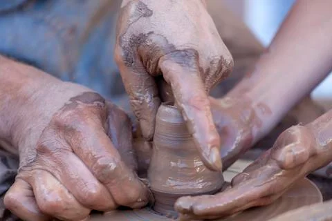 Hands working on pottery wheel Stock Photos