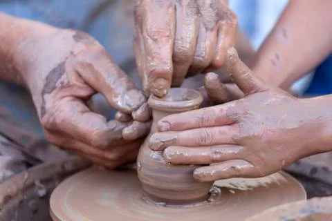 Hands working on pottery wheel Stock Photos
