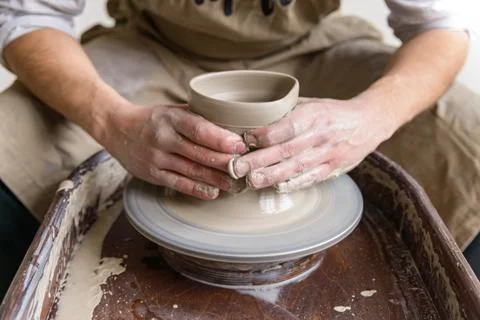 Hands working on pottery wheel 스톡 사진