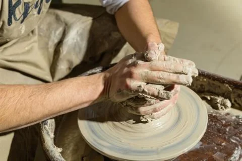 Hands working on pottery wheel Stock Photos