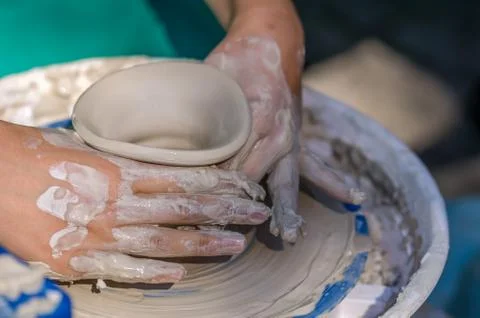 Hands working on pottery wheel Stock Photos