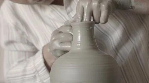 Hands working on pottery wheel, shaping a clay pot Video stock 68010704