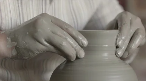 Hands working on pottery wheel, shaping a clay pot Video stock 68012878