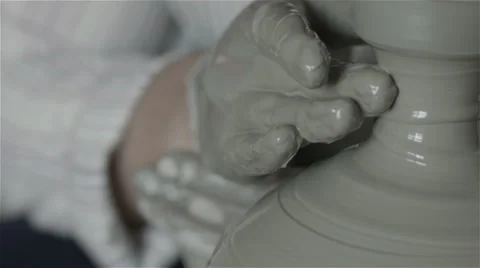Hands working on pottery wheel, shaping a clay pot Video stock 68017101