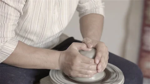 Hands working on pottery wheel, shaping a clay pot Stock-Footage 68048648