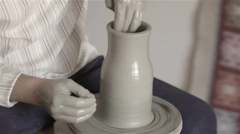 Hands working on pottery wheel, shaping a clay pot Video stock 68118168