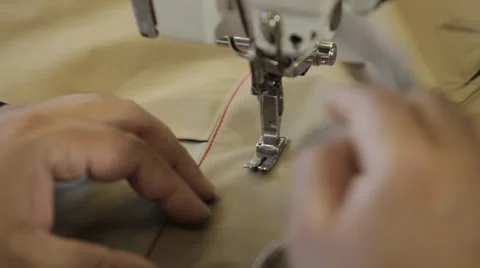 Hands working on a sewing machine in a dressmaker's factory (close up shot) Stock Footage 31361456