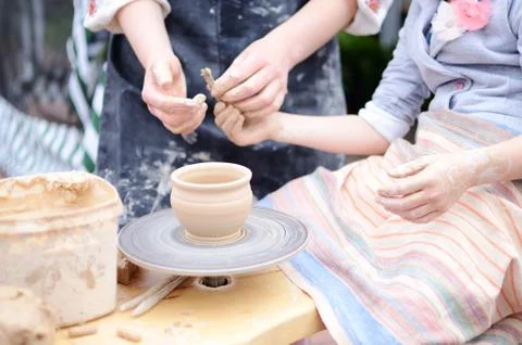 Hands working on throwing wheel, master class of studio pottery Stock Photos