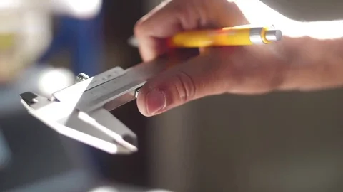 Hands working with vernier caliper stainless steel measuring Stock Footage 82755129