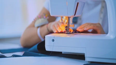The hands works with a sewing machine Stock Footage 107653038