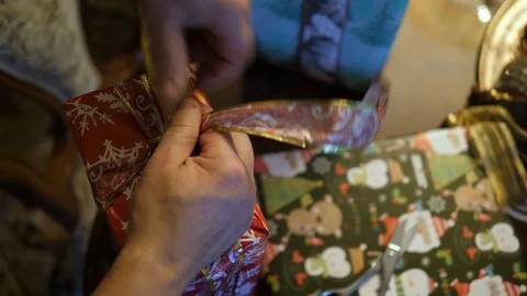 Hands Wrap Christmas red gift Bag. Closing with Ribbon bow. Isolated closeup. Stock Footage 129692987