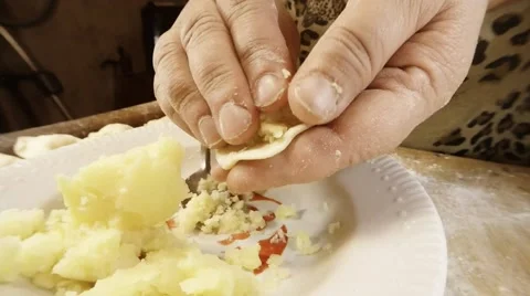 Hands Wrap in Paste Filling Plate With Potatoes Close up Stock Footage 66435392
