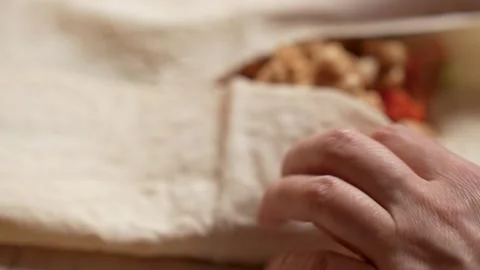 Hands wrapping chicken shawarma roll Stock Footage 262214833