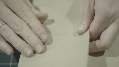 Hands wrapping invitation or present Stock Footage 160522283