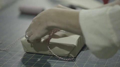 Hands wrapping invitation or present Video stock 160522307