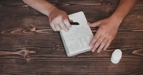 Hands writes phrase and taking pills. Top view close up Stock Footage 263018799