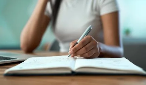 Hands, writing and notebook with remote work from home for freelance job, r.. Stock Photos