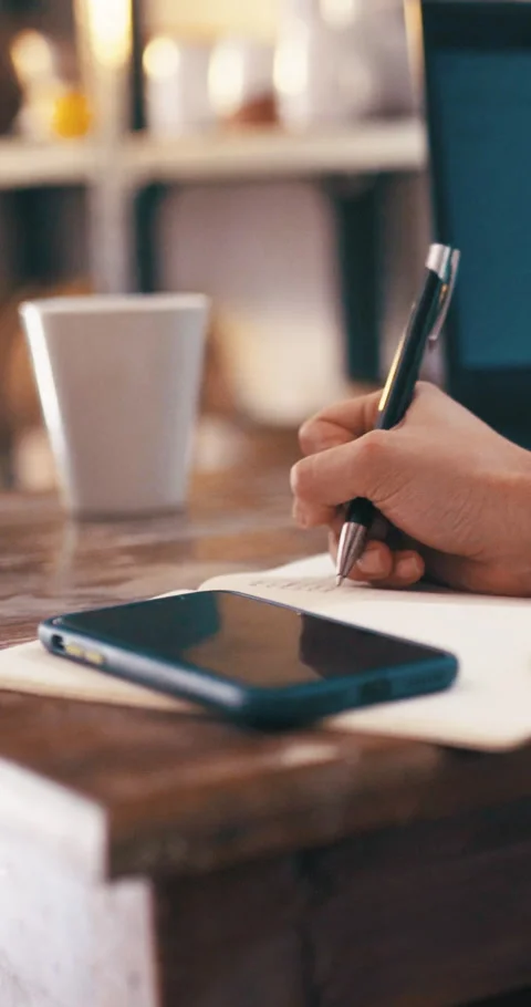 Hands, writing and planning in small business with notebook, phone and reminder Stock Footage 329759776
