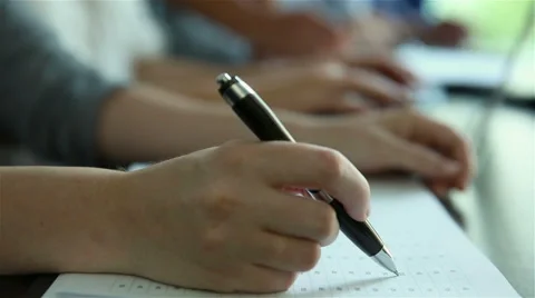 Hands writing and typing in classroom Stock Footage 53471464