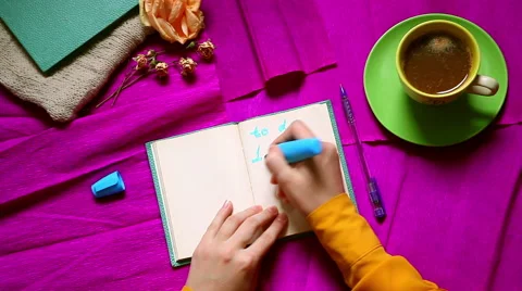 Hands writing to do list with 3 option . Top view. Purple background from above Stock Footage 57746997